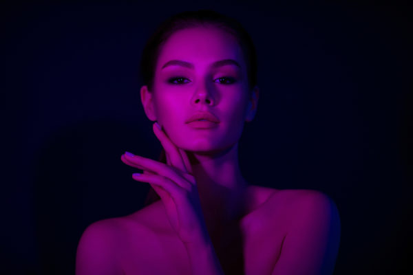 Woman on lilac neon background. Beauty. Neon. Make up.